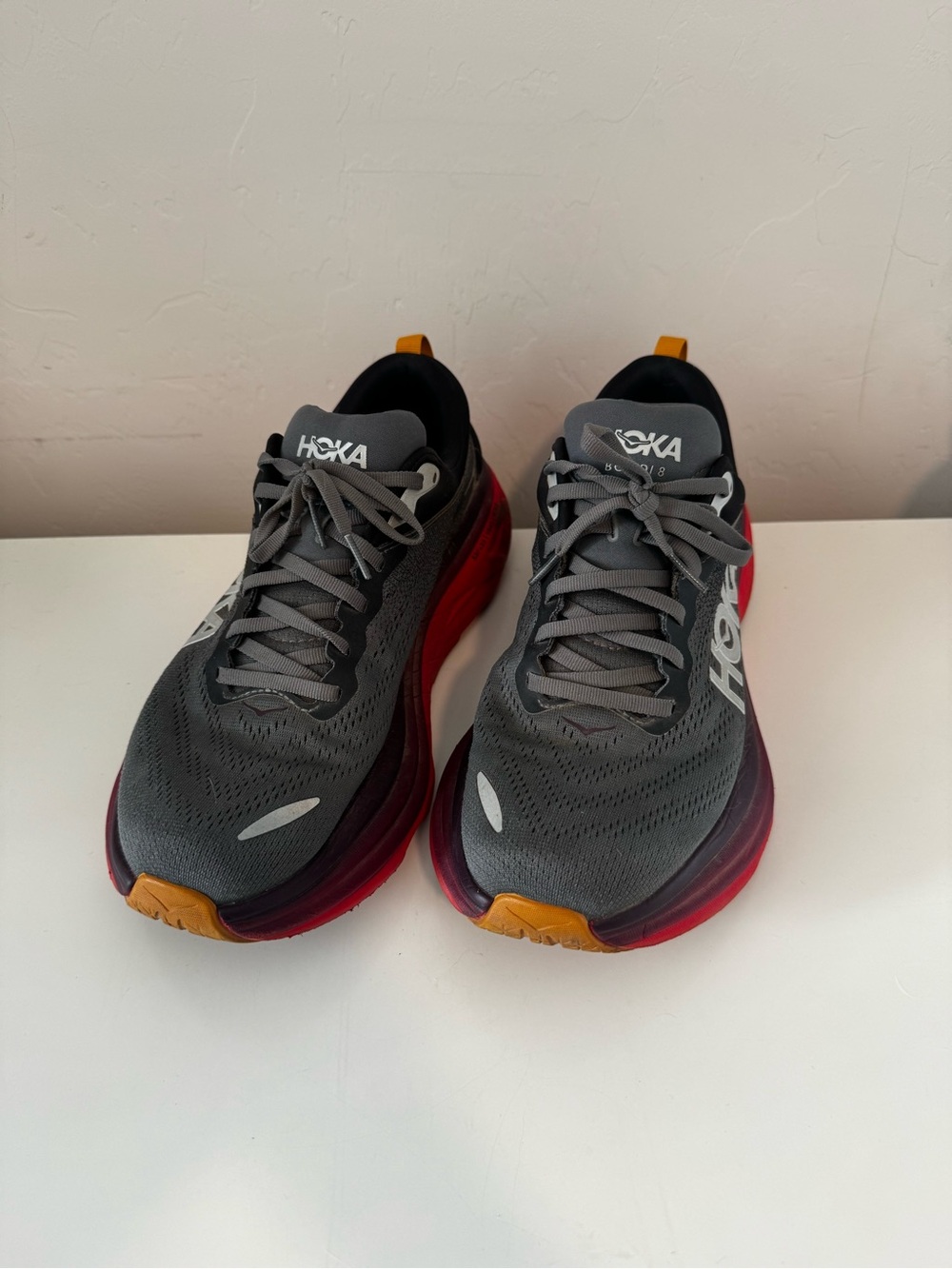 Hoka men’s Gray Sneakers with Red and Orange Accents